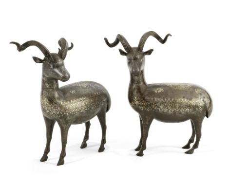 A pair of Qajar gold and silver damascened steel rams Persia, 19th Centuryeach standing upright facing left with head slightl