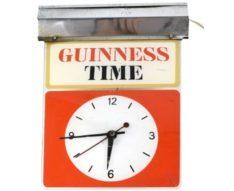 A vintage Guinness Time illuminated suspended clock with white dial within a red block, with the title 'Guinness Time' border