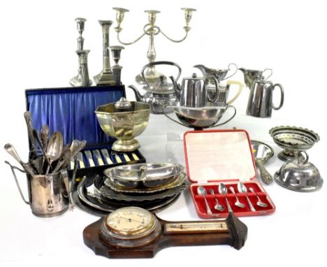 A large collection of silver plate to include two pairs of candlesticks, two three-piece tea sets, spirit kettle, circular tr