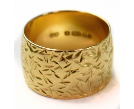 A vintage 1970s 18ct yellow gold wide band ring with all-over textured pattern, size O, approx 9.1g.