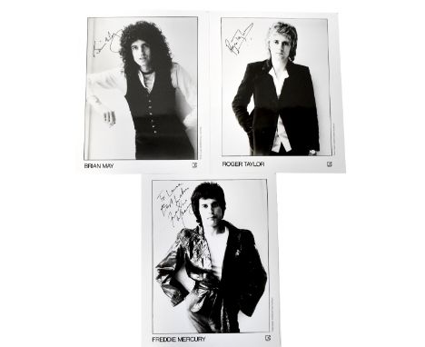 QUEEN; three individual black and white portrait photographs bearing the signatures of Freddie Mercury, Roger Taylor and Bria