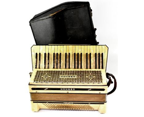 A cased Hohner Tango III piano accordion.  CONDITION REPORT The central key is sat proud of the rest of the keyboard and when
