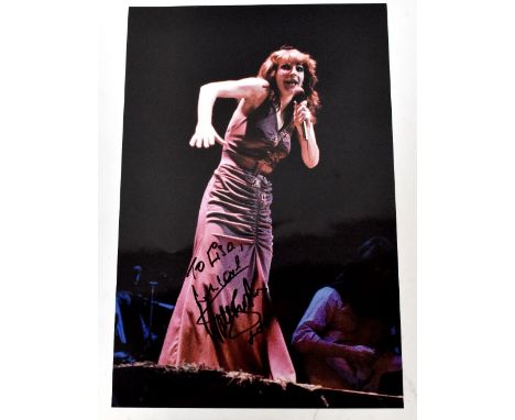 KATE BUSH; a colour photograph inscribed 'To Lisa, With love' and bearing the signature of the star beneath. CONDITION REPORT