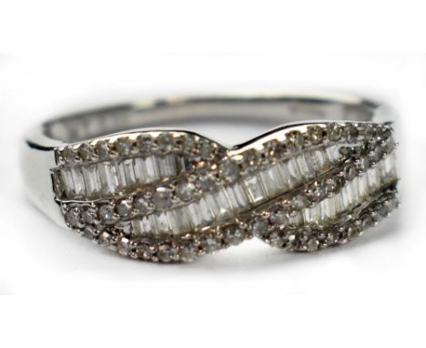 A modern 9ct white gold diamond cluster ring, the ribbon twist head set with a middle row of baguette cut small diamonds bord