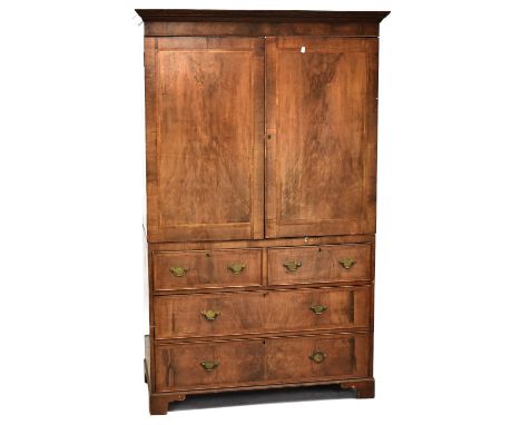 A walnut crossbanded and herringbone inlaid linen press with pair of panelled doors above two short and two long drawers, to 