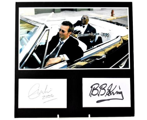 ERIC CLAPTON & B.B. King; a signed photograph dated 2006, the photograph of BB King riding in a Cadillac while playing a guit