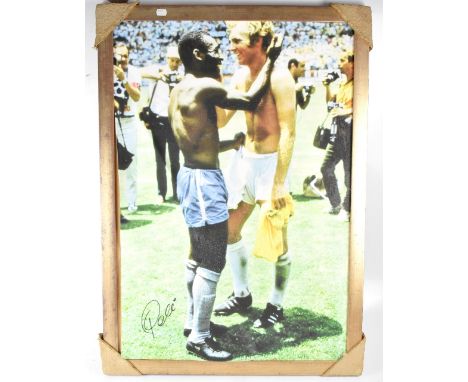 PELE; a reproduction canvas of Pele and Bobby Moore, hand signed by Pele with certificate of authenticity verso, from Osborne