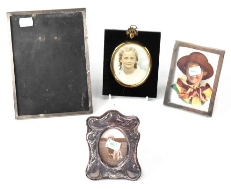 An Elizabeth II hallmarked silver photograph frame in the Art Nouveau style, London 1989, two other hallmarked silver photogr