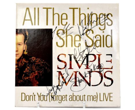SIMPLE MINDS; a 45rpm single 'All the Things She Said', bearing signatures of the band members to the sleeve.We have not auth