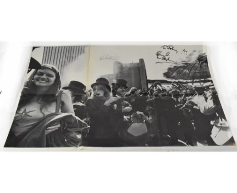 PAUL & LINDA MCCARTNEY; a folded poster inscribed 'To Johnny!!!' and bearing the signatures of Paul McCartney and Linda McCar