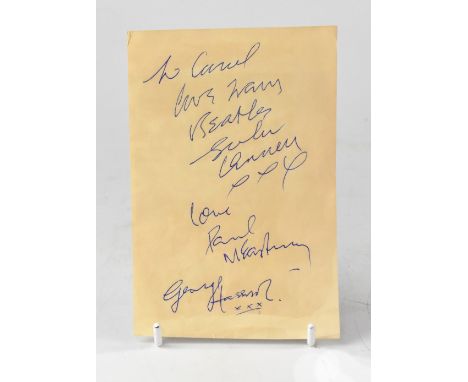 THE BEATLES; a cut piece of paper from a book inscribed 'To Carol, love from Beatles' and bearing the signatures 'John Lennon