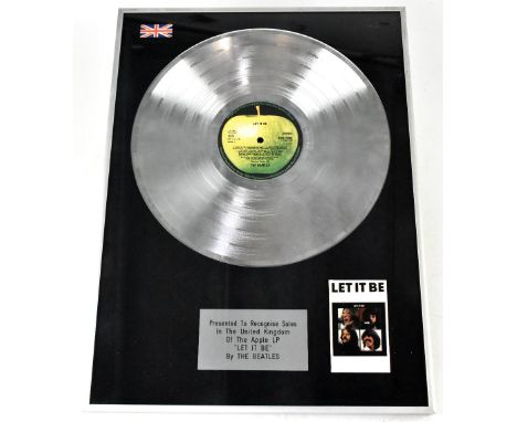 THE BEATLES; an LP Platinum disc presented to recognise sales in the United Kingdom of the Apple LP 'Let it Be' by The Beatle