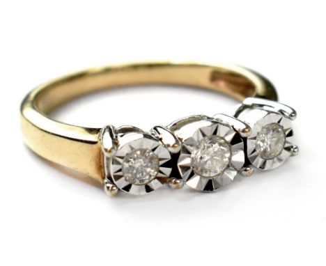 A 9ct gold three stone diamond ring, the three illusion set diamonds in a white metal gallery, on a 9ct gold shank, size N. C