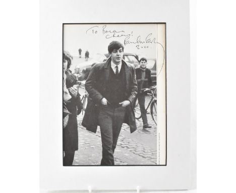 PAUL MCCARTNEY; a printed black and white photograph inscribed 'To Brian, Cheers!' bearing the signature of Paul McCartney an