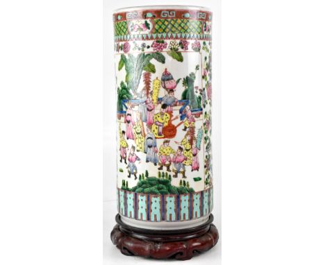 A Chinese cylindrical vase/stick stand in the Famille Rose palette, with figural panels and floral decoration depicting peoni