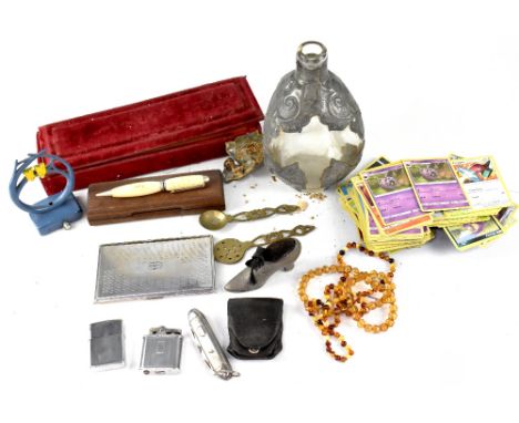 A collector's lot comprising vintage lighters, a pin cushion in the form of a shoe, Pokémon cards, costume jewellery, etc.