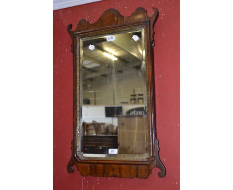 A George II design walnut and parcel-gilt Vauxhall looking glass, shaped cresting, bevelled plate, 76cm high, c.1900 