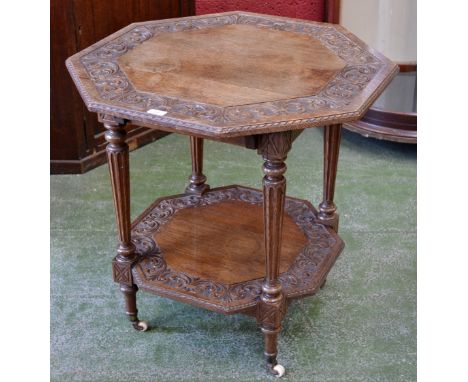 An Victorian Oak two tier octagonal occasional table, ceramic castors