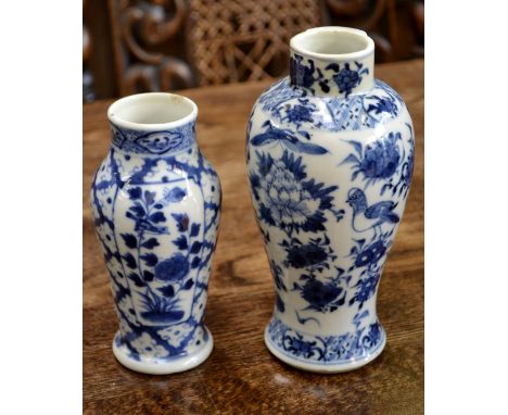 A Chinese slender baluster vase, decorated in underglaze blue with stylised bird, peony and foliage, the neck with banded bor