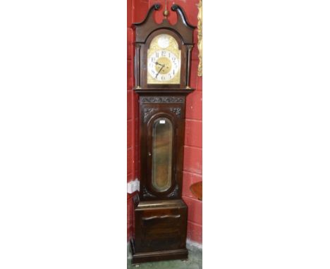 An Edwardian mahogany longcase hall clock, arched dial, Arabic numerals, twin winding holes, glazed rectangular door to waist