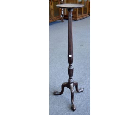 A 19th century mahogany tripod torchere or statuary pedestal, dished circular top above a lotus capital, turned, reeded and f