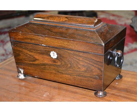A Victorian rosewood sarcophagus tea caddy, loose ring handles, bun feet, the interior with two lidded compartments and bowl 