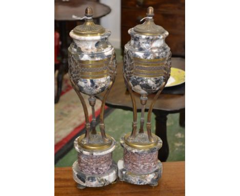 A pair of 19th century gilt metal mounted breccia and rouge marble ovoid mantel urns, acorn finials and underfinials,tripod s