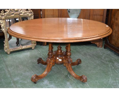 A Victorian mahogany oval breakfast table, moulded top, turned quatre-columnar base, spire underfinial, cabriole legs carved 