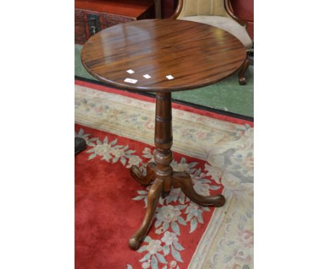 A mahogany tripod table, circular top, turned and ribbed column, cabriole supports, scrolling feet. 81cm high x 58.5cm diamet