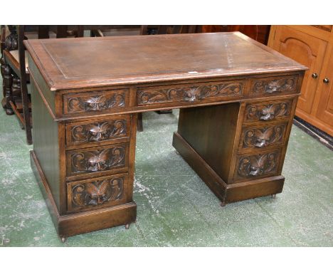 A Victorian oak pedestal desk, moulded rectangular top with tooled and gilt writing surface above three frieze drawers heavil