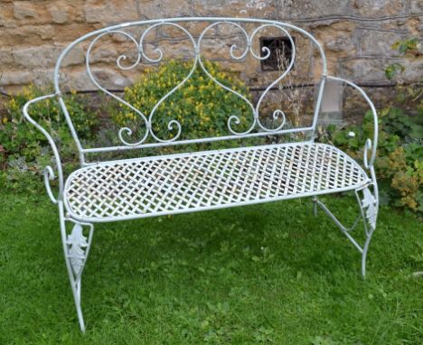 A light green painted metal garden bench, 132 cm wide, a matching table and two chairs (4) 