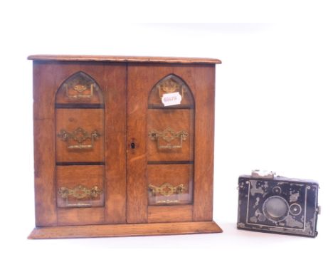 An oak table top chest, 31 cm wide, a Troger & Soller camera, accessories, cigars, a silkwork picture of a lion and lioness, 