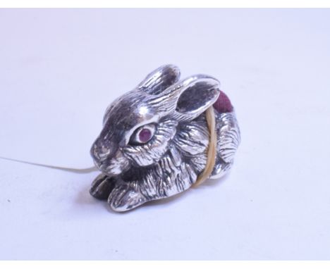 A silver pincushion, in the form of a rabbit, with ruby eyes, 3.5 cm high   Condition report  Report by NGModern