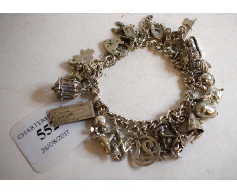 A modern silver charm bracelet, with charms, a silver thimble, a silver bangle, and other items   Condition report  Approx. w