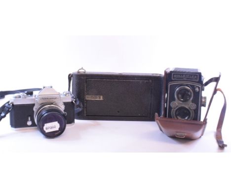 A Rolleiflex camera, a Nikkormat camera, other cameras and accessories (box)