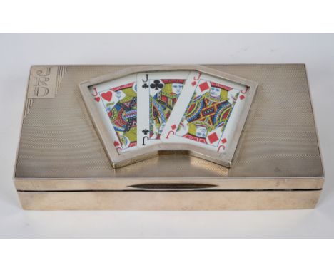 A silver table top playing card box, initialled, the top inset three playing cards, and with engine turned decoration, London