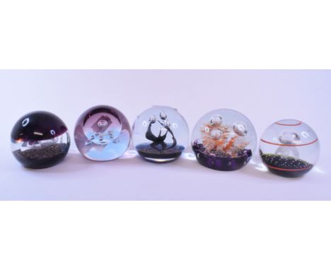 A Caithness Glass limited edition paperweight, designed by Colin Terris, Touchdown, 620/1000, and four others similar, all bo