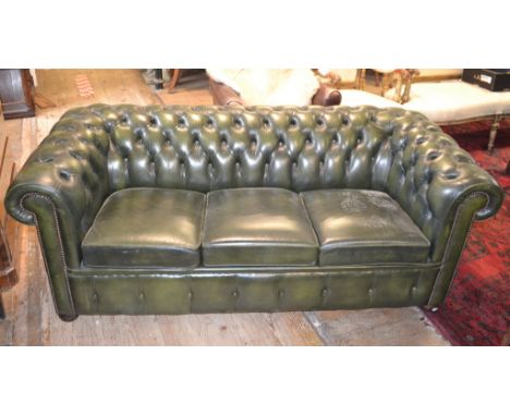 A green leather upholstered button back three seater settee, with a matching club armchair (2)