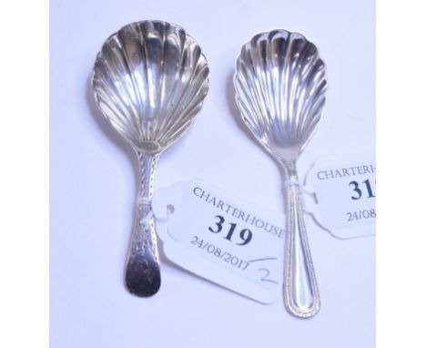 A silver caddy spoon, initialled, with bright cut decoration and a shell bowl, probably London 1787, and a similar silver cad