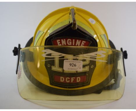 An American Cairns & Brother firefighter's helmet, for Engine 112 of the District of Columbia Fire Department, and a yellow f