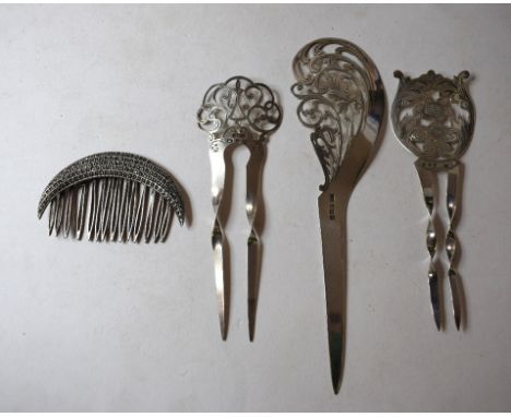 A silver hair comb, Birmingham 1898, two other silver hair combs and other assorted combs, grips and items