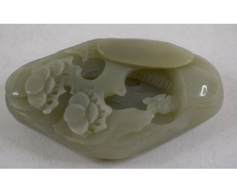 A jade pebble, carved a scholar in a landscape, 8 x 5 cm 