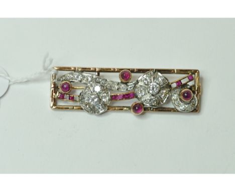 A diamond and ruby panel brooch, in a yellow coloured metal mount (some stones missing)   Condition report  Report by NGAppro