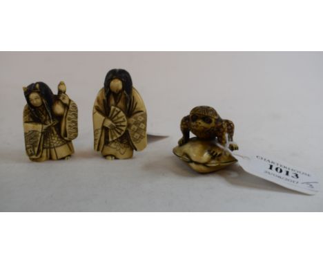 A 19th century Japanese carved ivory netsuke, in the form of a toad on a clam shell, two character mark to underside, and two