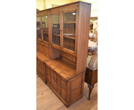 An Ercol elm triple wall unit, in three sections, 98 cm wide (3)