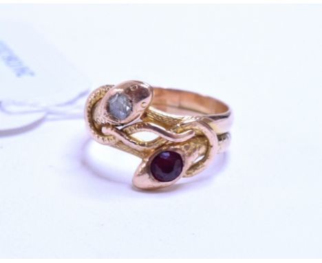 A yellow coloured metal double serpent ring, one serpent head set a diamond, the other set a ruby, approx. ring size N   Cond