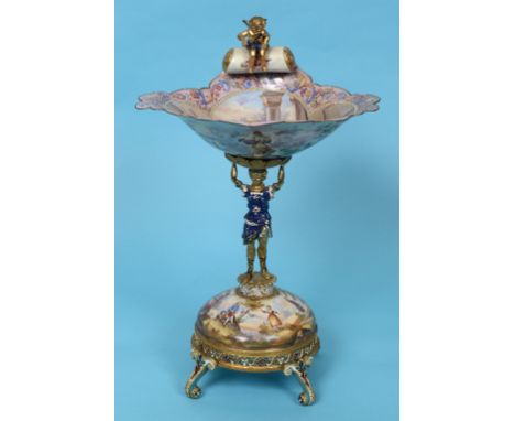 An Austrian silver gilt coloured metal and enamel comport, with a cherub finial, the bowl interior decorated figures and dogs