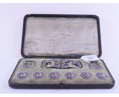 A set of six Art Nouveau silver buttons, with matching buckles and a belt buckle, Birmingham 1901, and with enamel style deco