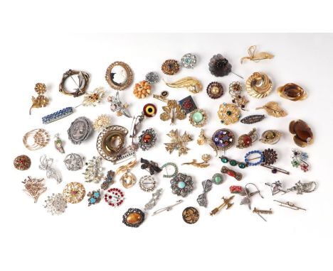 A large quantity of vintage costume jewellery brooches.