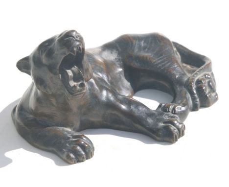 A bronze study of a yawning recumbent tiger, 16cms long.